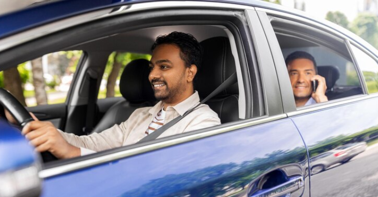 Just Cab Hire driver assisting passenger with luggage